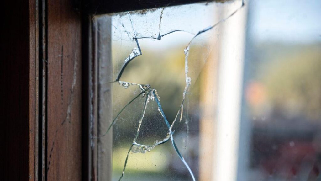 Can cracked window glass be repaired when small cracks and chips appear on a residential window pane near a wooden frame.